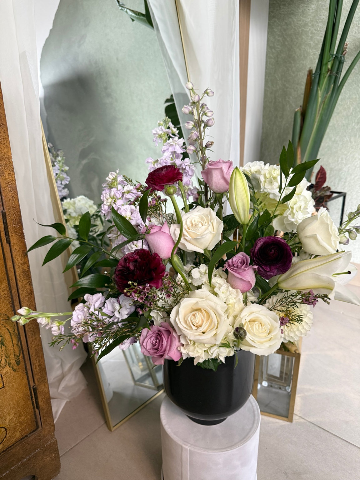 Close view of flowers in the black vessel arrangement
