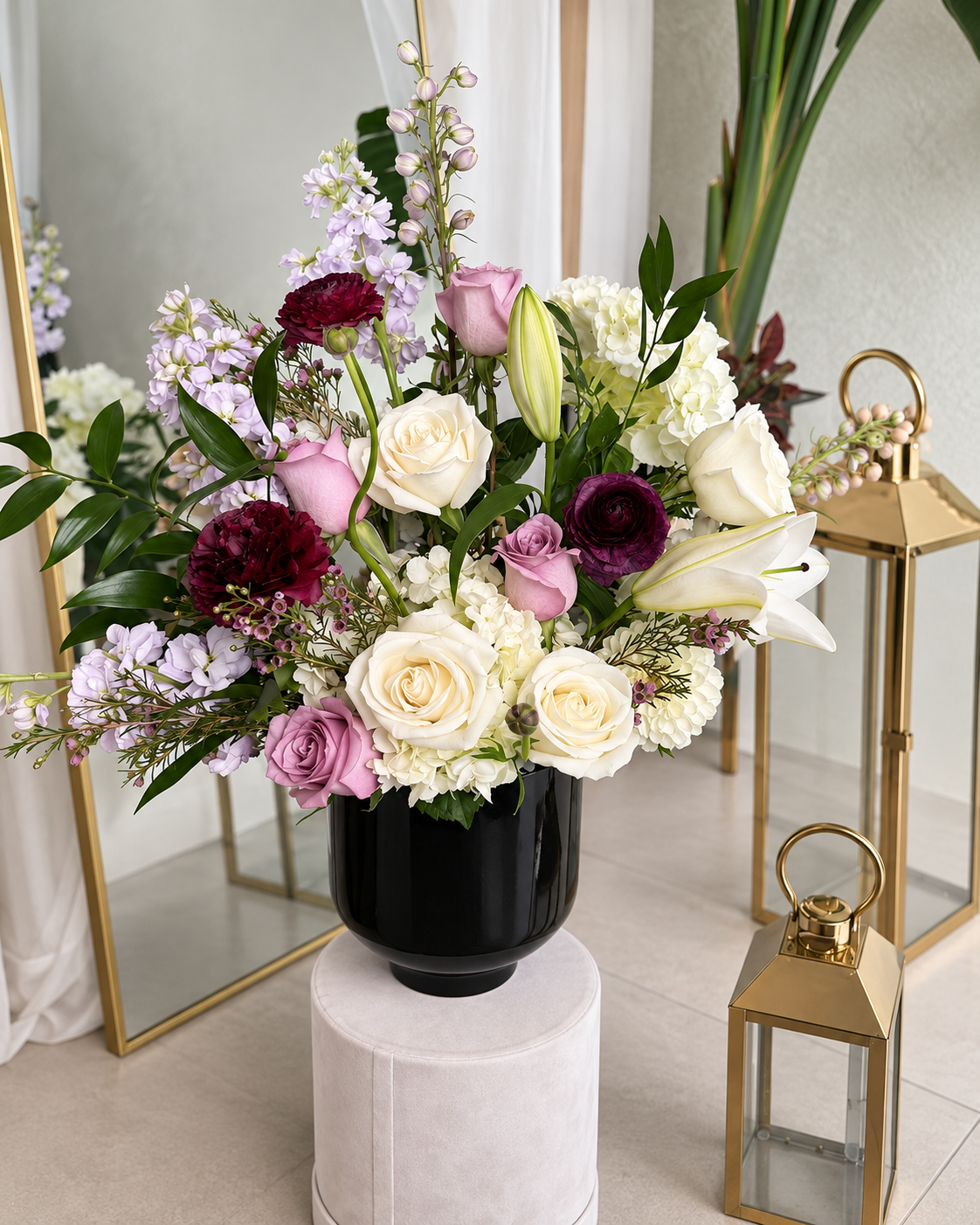 Luxury ivory, blush and wine floral arrangement in a black vessel