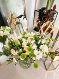 The Ivory Garden white and green flowers in a clear glass vase