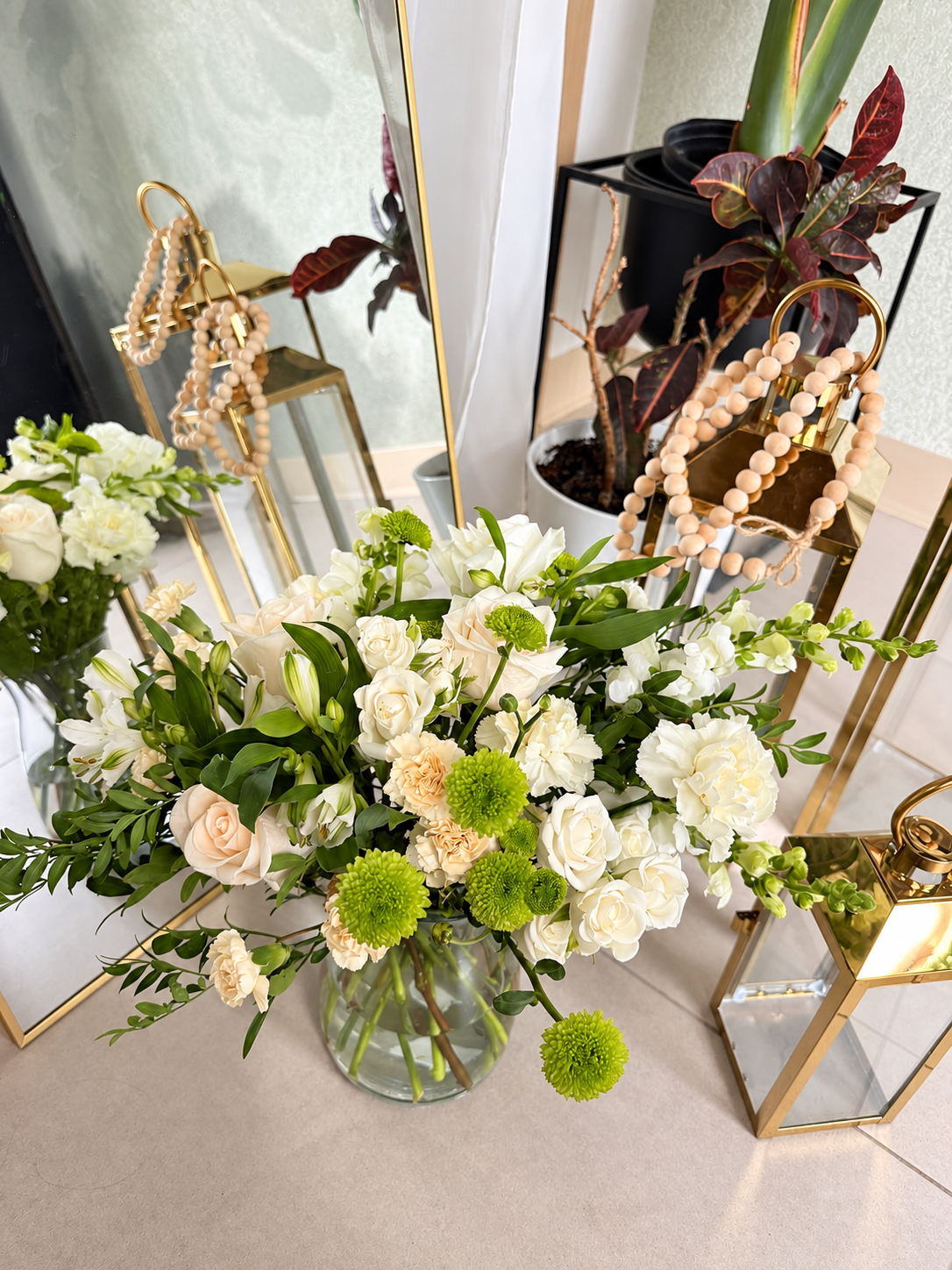 The Ivory Garden white and green flowers in a clear glass vase