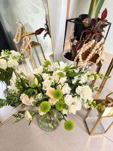 The Ivory Garden white and green flowers in a clear glass vase